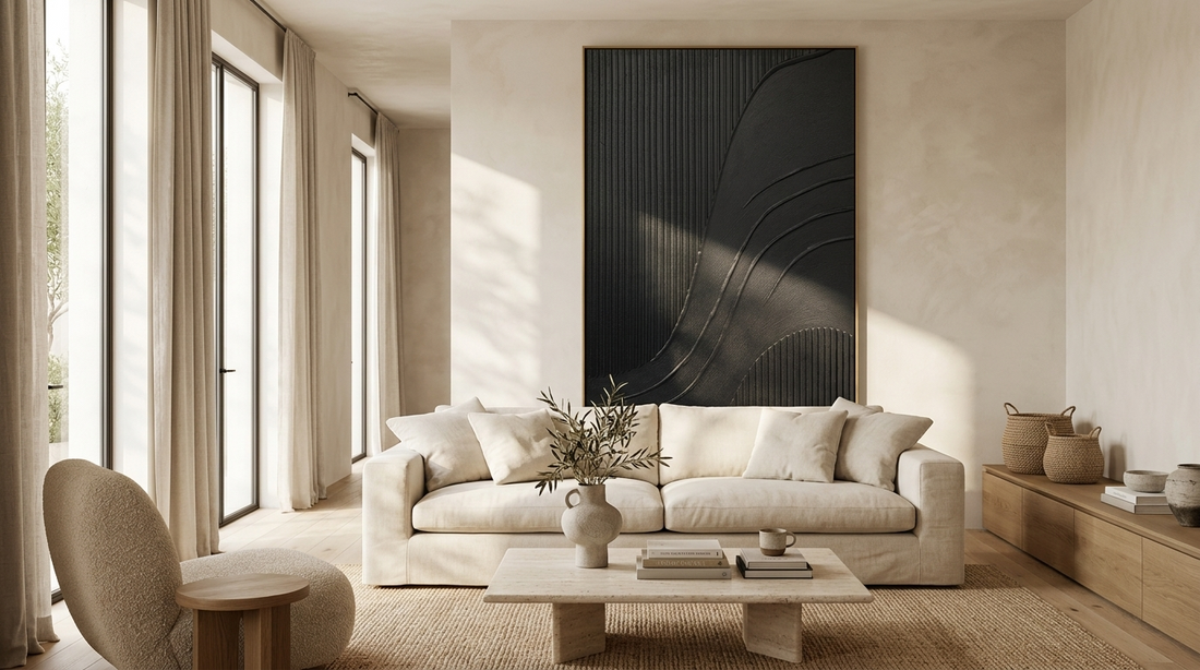 Black textured wall art displayed above a sofa in a modern minimalist living room