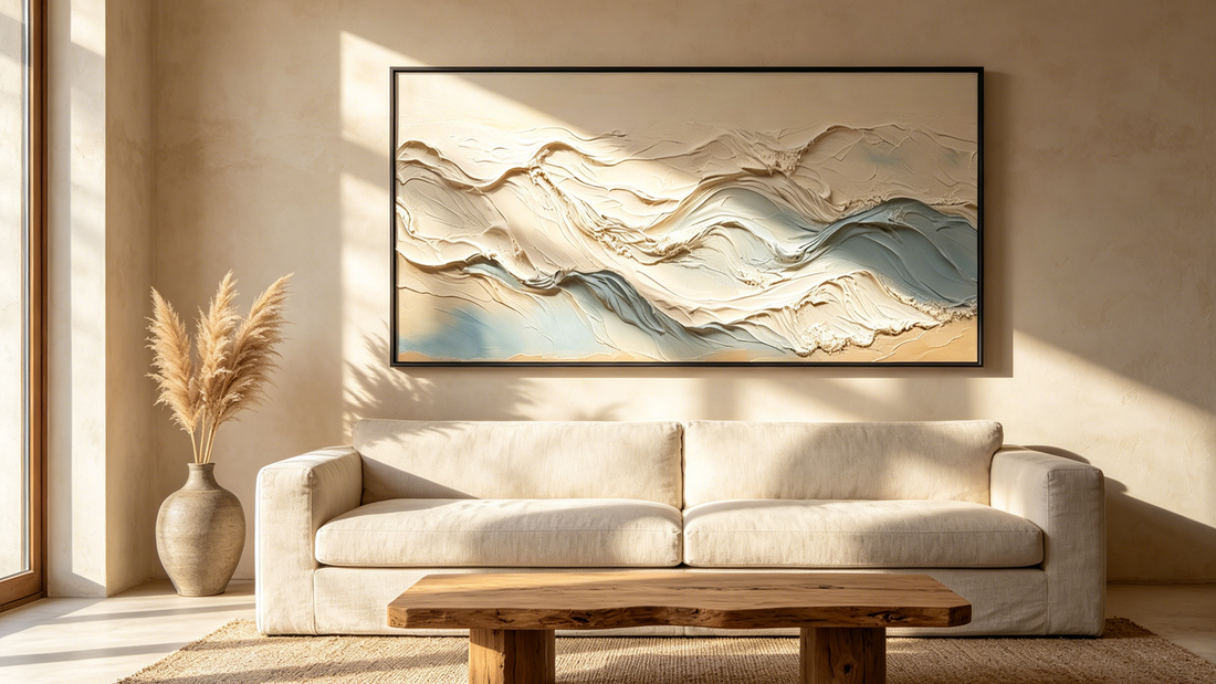 Textured ocean wall art displayed above a beige sofa in a modern coastal-inspired living room with neutral tones and organic modern decor