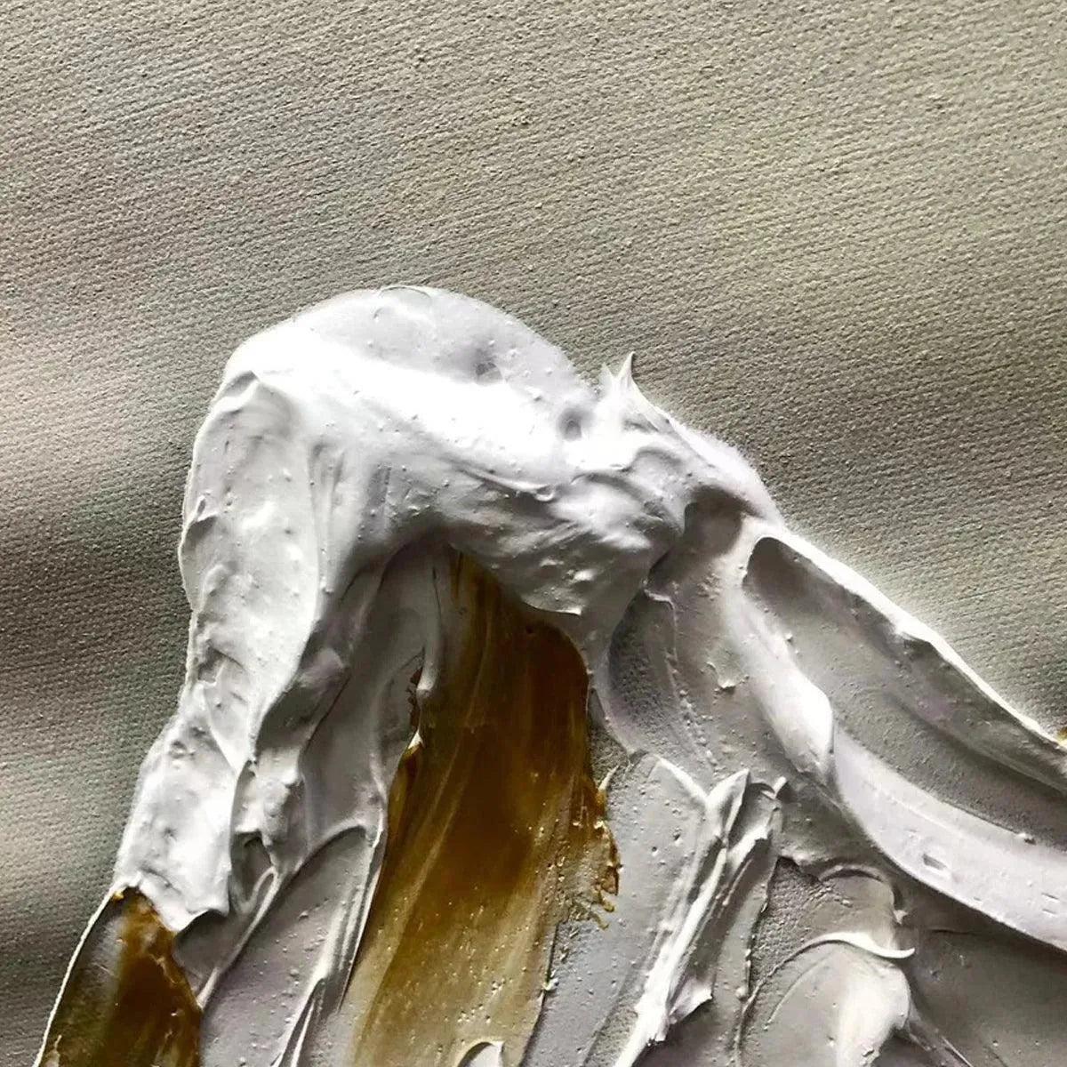 Close-up impasto painting texture: thick white peaks with gold accents on canvas, showcasing material quality.