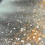 AURORA DUST: Close-up texture of abstract painting with gold, white, brown speckles on grey and teal.