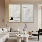 White textured diptych by Javier Ramirez, minimalist art, gold framed vertical wall art set in a living room.