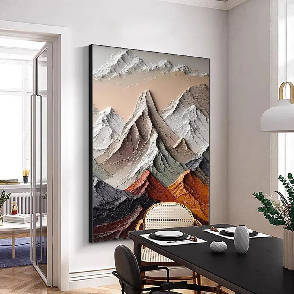 Textured impasto painting of majestic mountain peaks in earthy tones, displayed in a dining room setting.