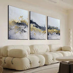 Gold and Grey Abstract Triptych: Textured impasto painting set of 3 vertical canvases above a cream sofa.