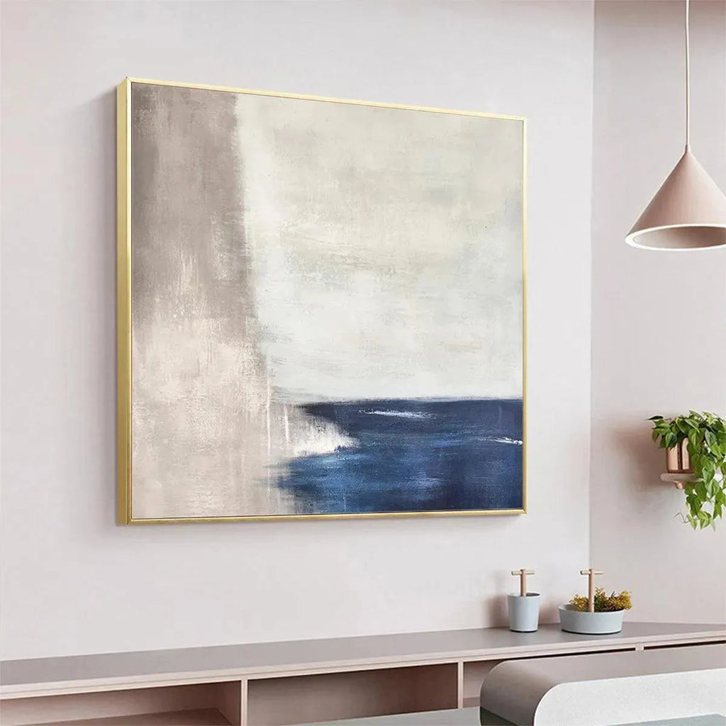 SERENE SHORE minimalist abstract coastal painting by Javier Ramirez, blue and beige tones, gold frame, modern home decor