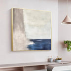 SERENE SHORE minimalist abstract coastal painting by Javier Ramirez, blue and beige tones, gold frame, modern home decor