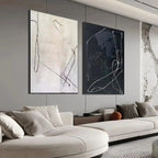 Javier Ramirez minimalist black & white abstract art duo in black frames, styled in a living room.