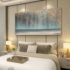 AURORA DUST: Horizontal abstract ocean painting with gold speckles above bed in modern bedroom. Textured blues, greys, gold.