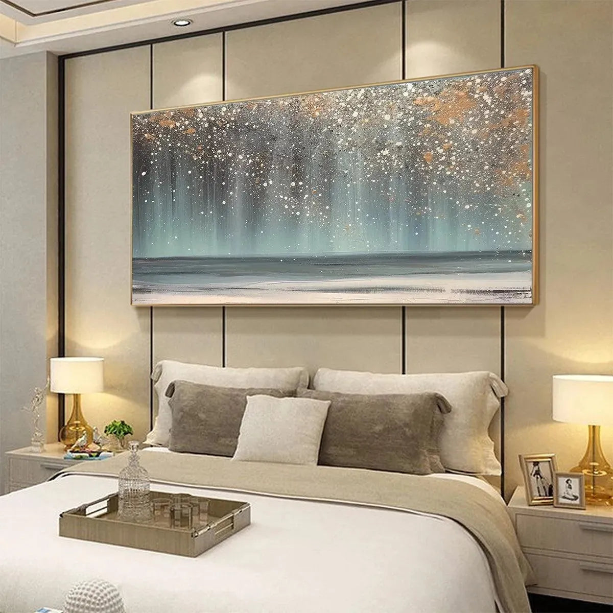 AURORA DUST: Horizontal abstract ocean painting with gold speckles above bed in modern bedroom. Textured blues, greys, gold.