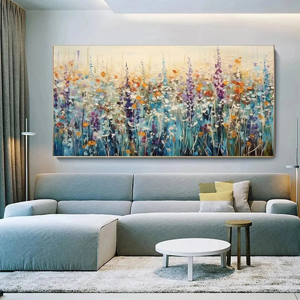 Impasto wildflower meadow painting in a living room. Vibrant purple, orange, blue, white blooms with textured strokes.