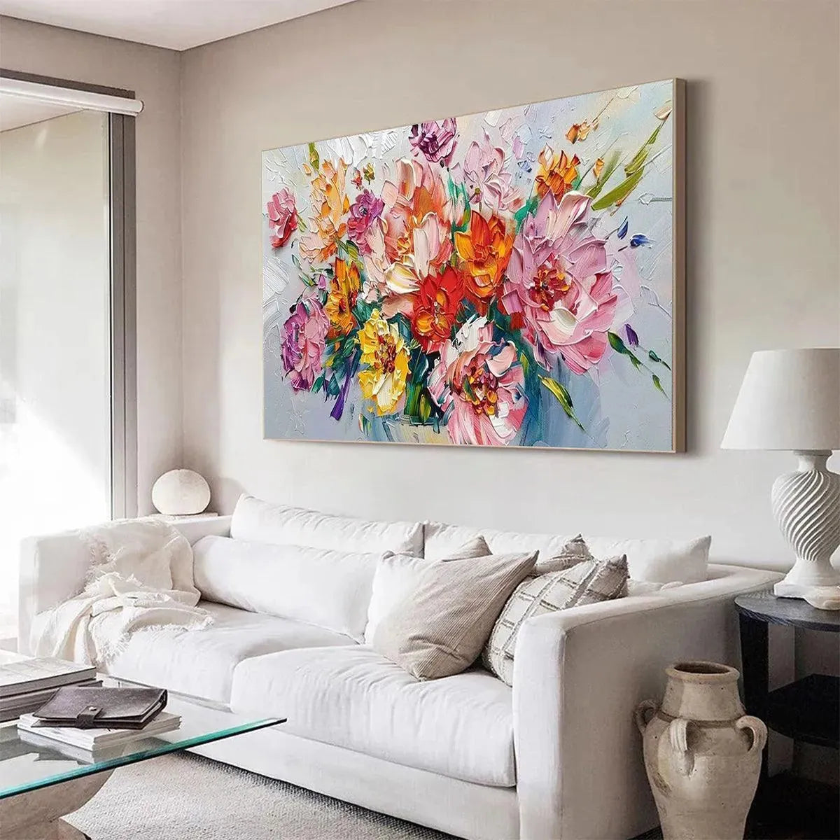 Vibrant impasto floral bouquet painting by Isabella Rossi displayed in a modern living room above a white sofa.