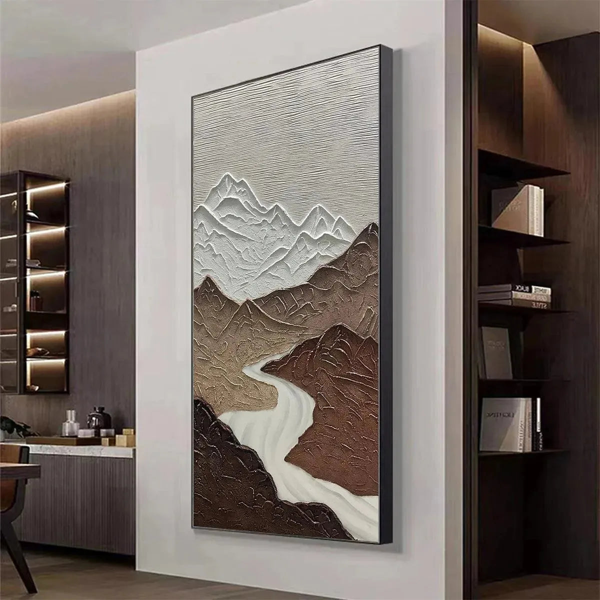 EARTH RIVER textured vertical painting: Brown mountains with white peaks and a winding river, displayed in a modern home.