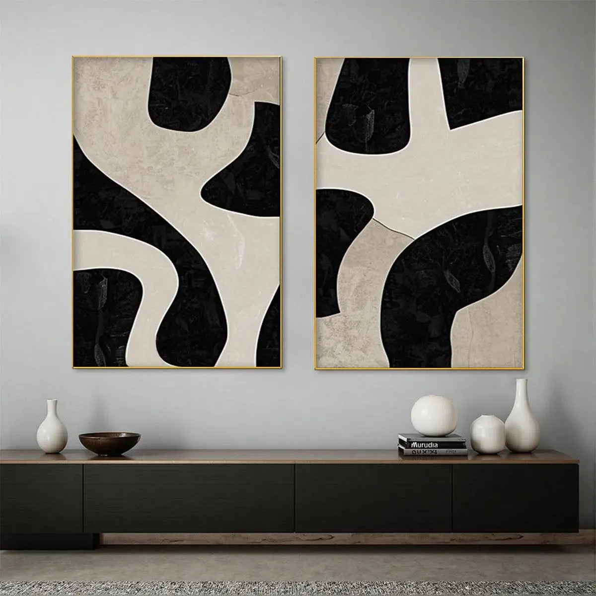 Black and beige abstract diptych with organic geometric shapes in gold frames, minimalist wall art.