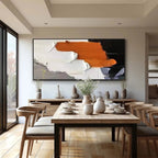 ORANGE BURST abstract painting by Isabella Rossi in a dining room. Orange, white, and black brushstrokes.