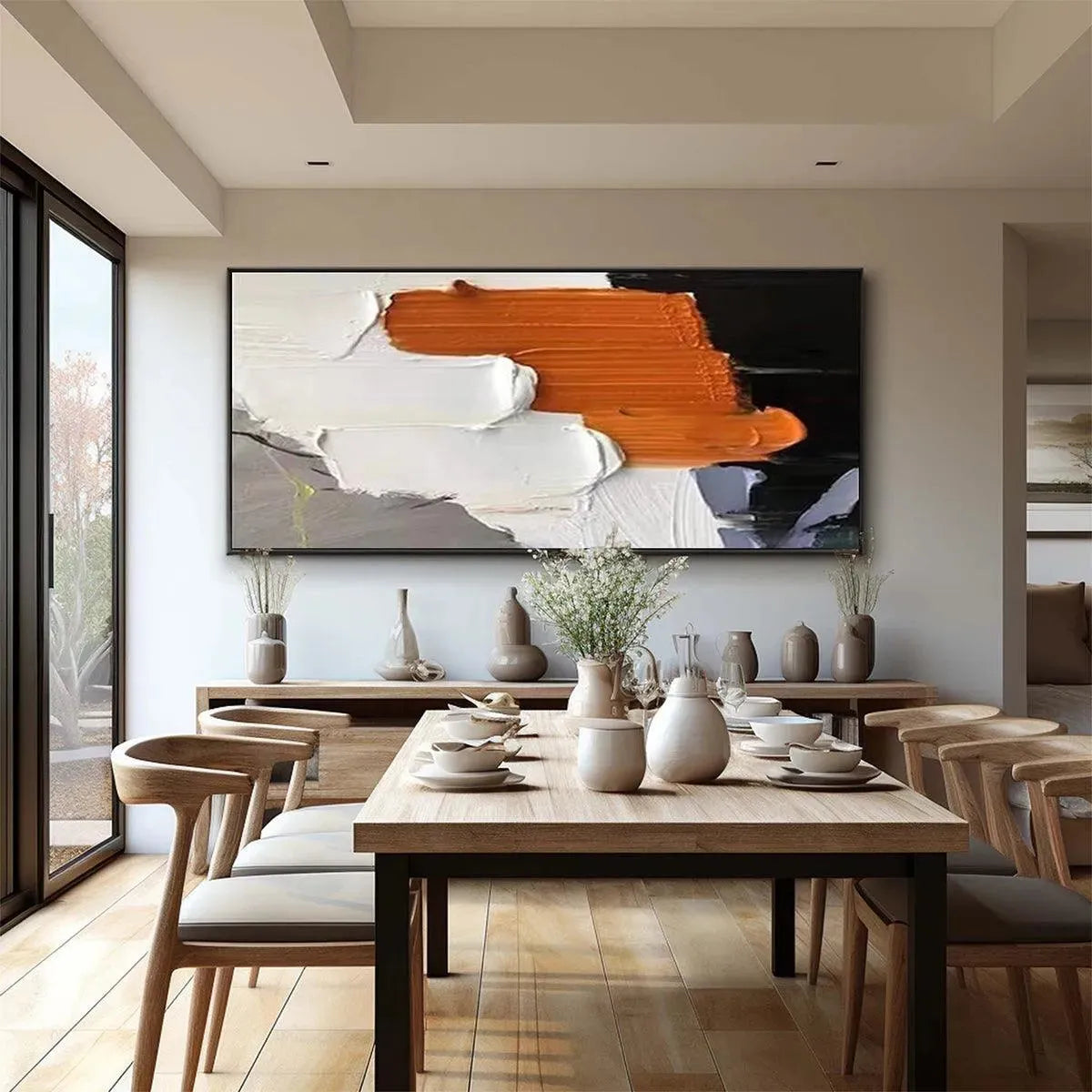 ORANGE BURST abstract painting by Isabella Rossi in a dining room. Orange, white, and black brushstrokes.