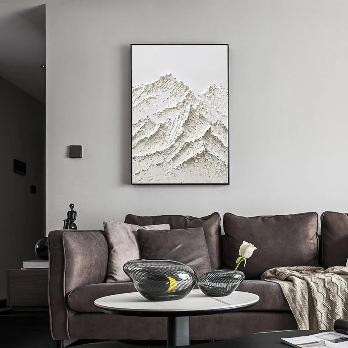 Liam O'Connell textured white mountain impasto painting in black frame, over sofa in modern living room.
