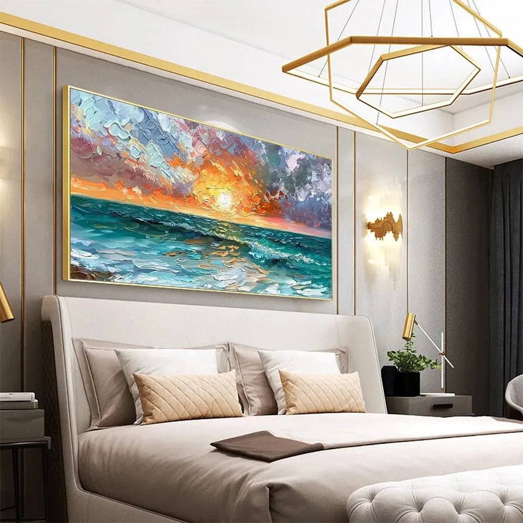 Vibrant impasto Ocean Sunset artwork with textured waves in a gold frame, creating a calming focal point in a modern bedroom.