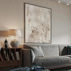 Textured Beige Abstract painting by Javier Ramirez, modern art with neutral tones and black frame in living room.