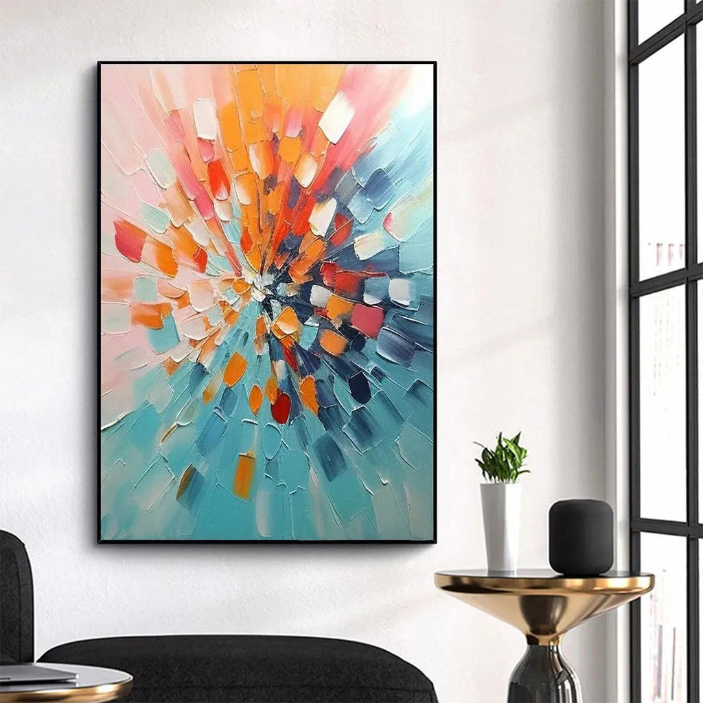 Vertical textured impasto art, 'Radiant Burst', with orange, blue, red strokes in black frame, modern living room decor.
