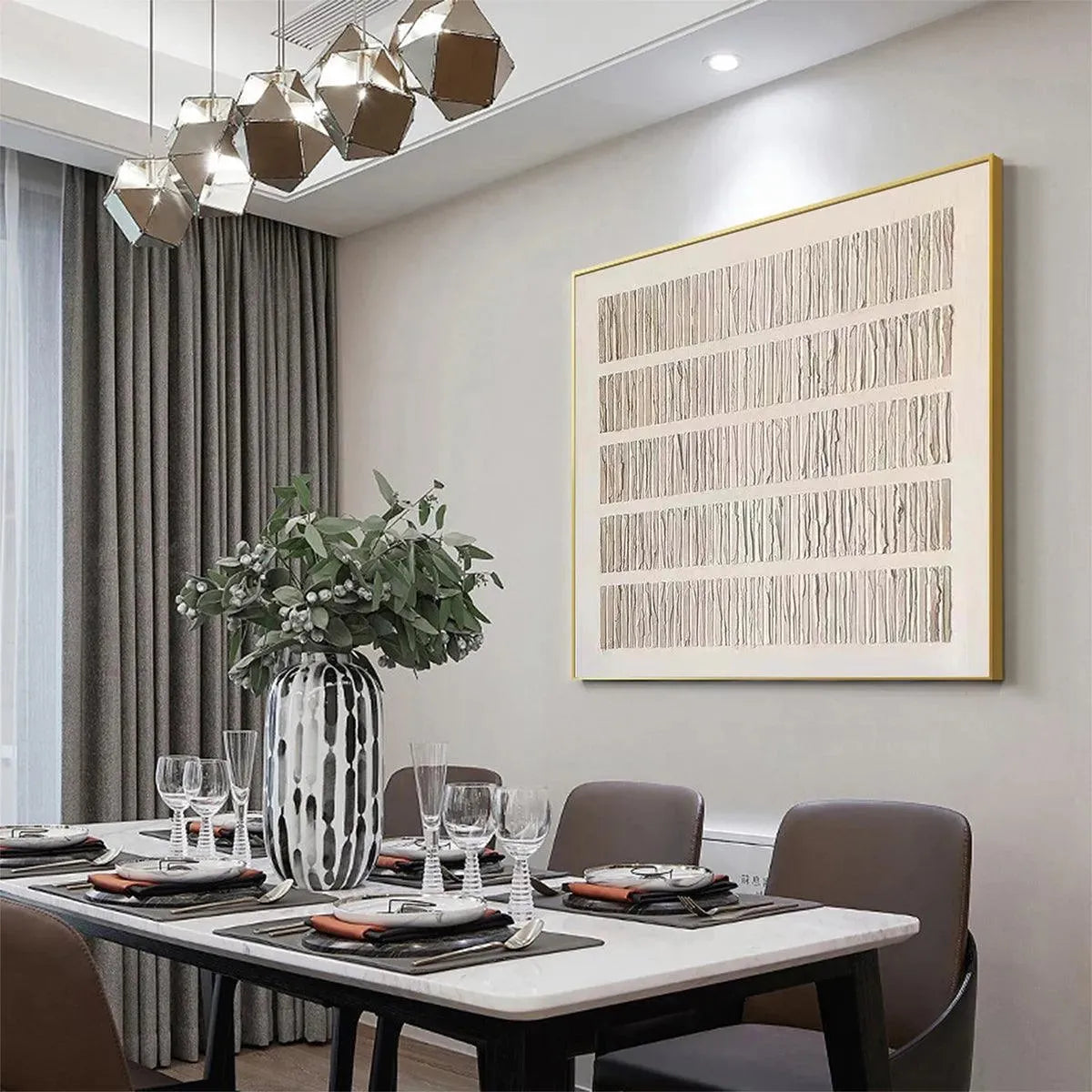 Minimalist textured beige wall art with vertical lines in gold frame, styled in contemporary dining room setting.