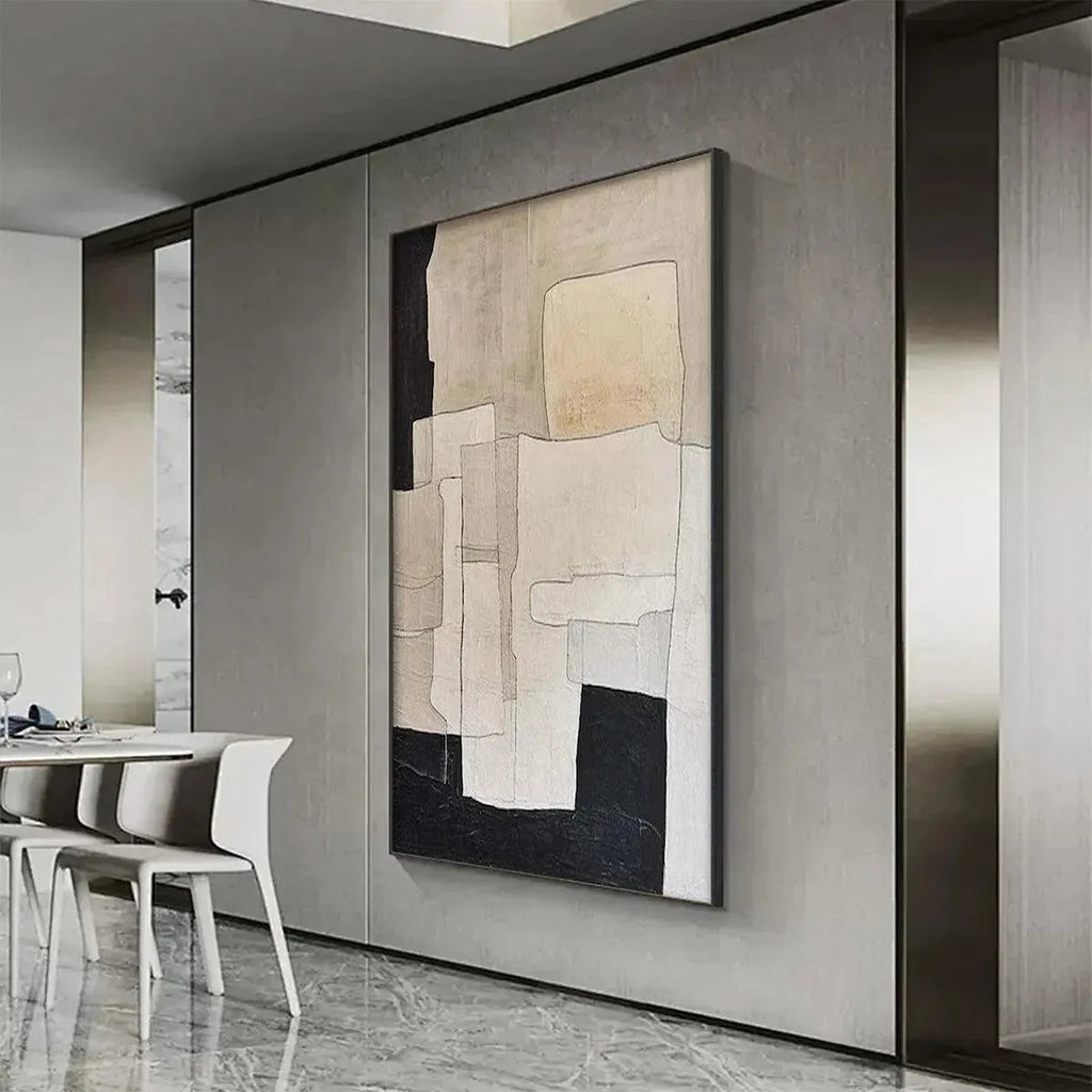 Javier Ramirez minimalist abstract painting in beige and black with geometric shapes on a grey wall.