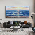 Golden Sunset Serenade ocean painting displayed above a gray sofa in a contemporary living space.