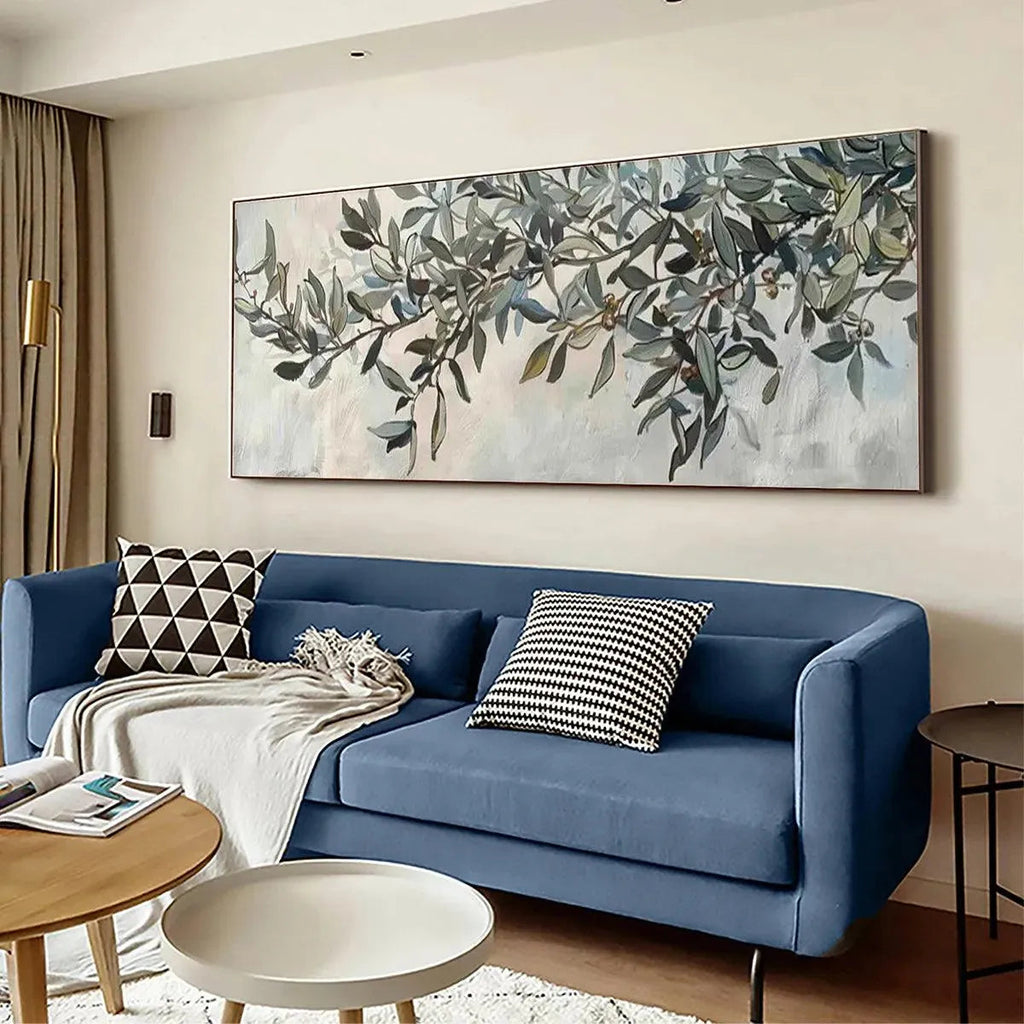 Liam O'Connell's panoramic olive branch painting on wall above blue sofa