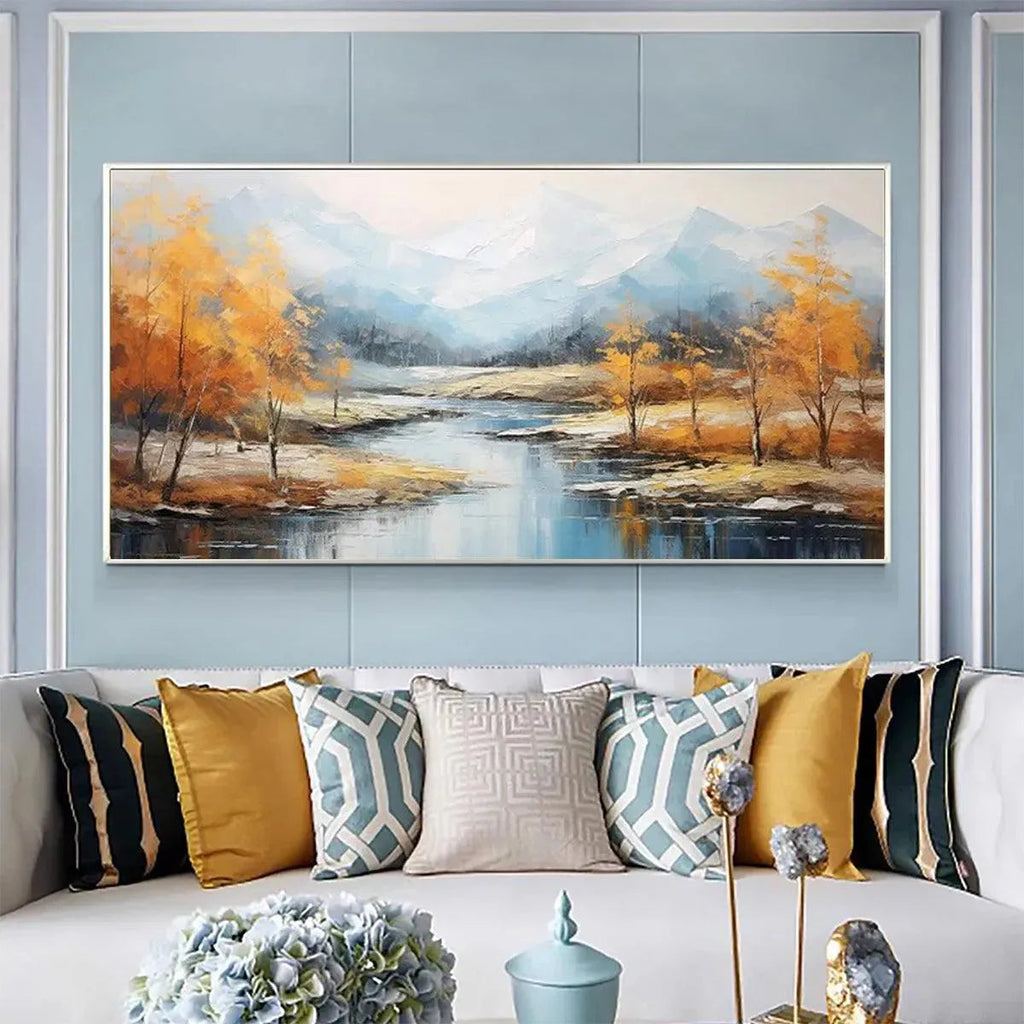 Golden Autumn Valley painting: golden trees, blue river, misty mountains, framed above a living room sofa.