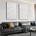 Isabella Rossi's White Waves Diptych: White textured abstract art on canvas, black frame, vertical wall decor.