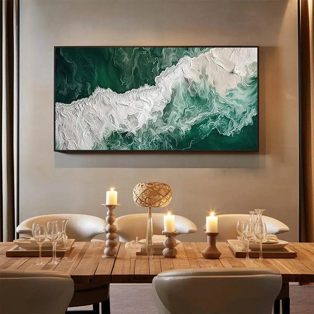 Horizontal Emerald Flow abstract ocean painting, textured green & white, enhances a modern dining room with candles.