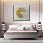 Golden Harmony abstract painting in a bedroom, featuring textured gold concentric circles on a white background.