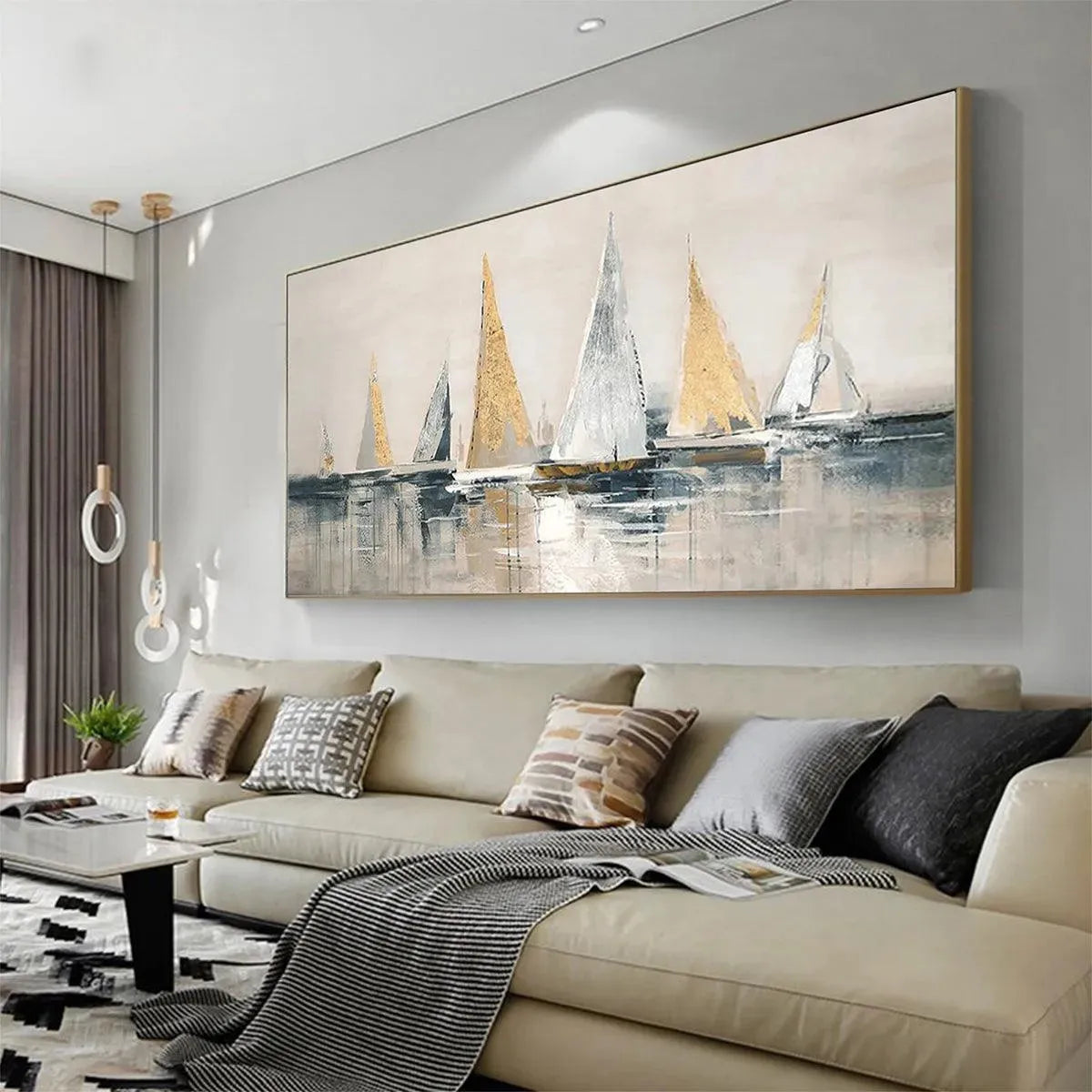 Golden Sailboats by Isabella Rossi, gold and silver sailboat seascape, horizontal wall art above a beige sofa.