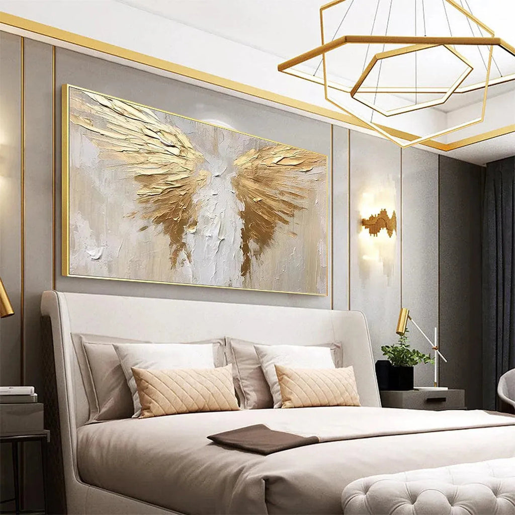 Textured abstract painting of golden wings on beige background, displayed above a bed in a modern bedroom.