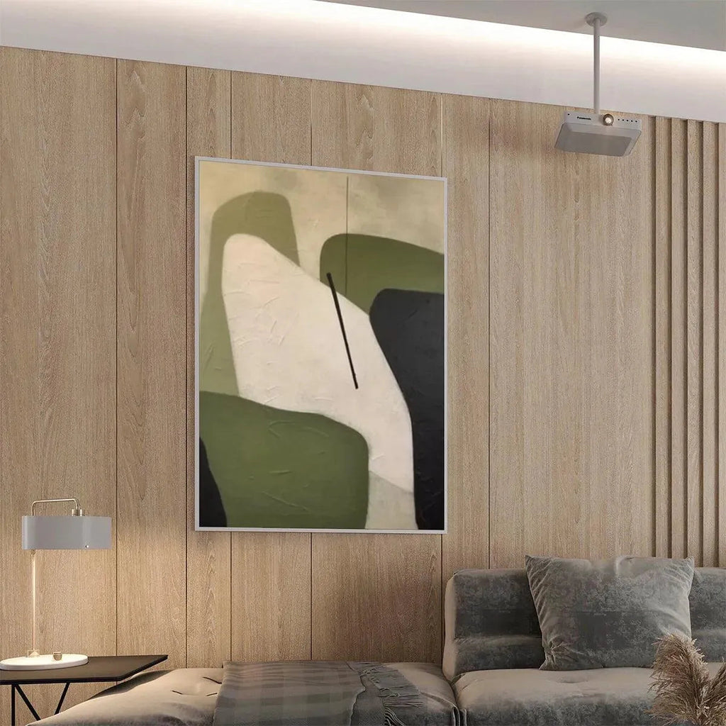 Minimalist green abstract painting with organic shapes, olive green, cream, and black, displayed in a modern living room.