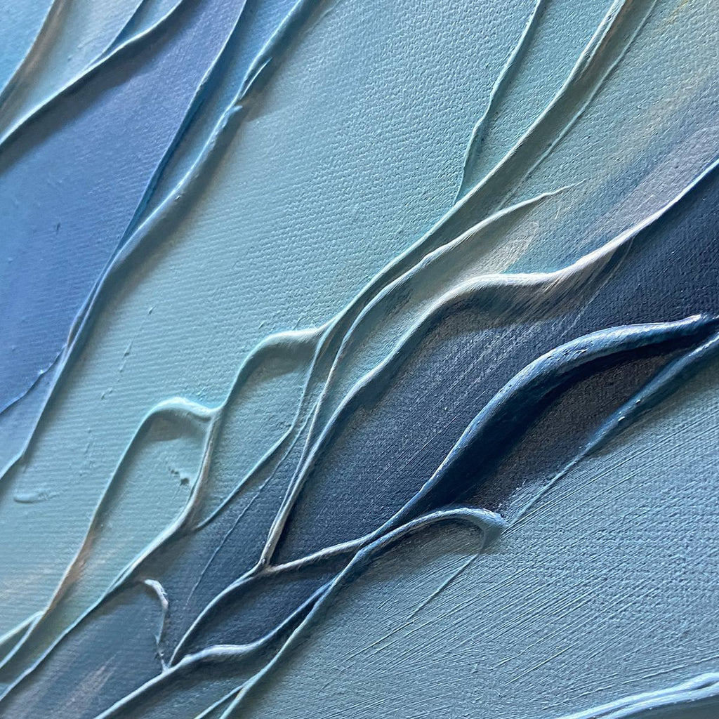 Liam O'Connell 'Cresting Wave' textured seascape painting; dramatic blue ocean wave, white foam, sunset sky, black frame.