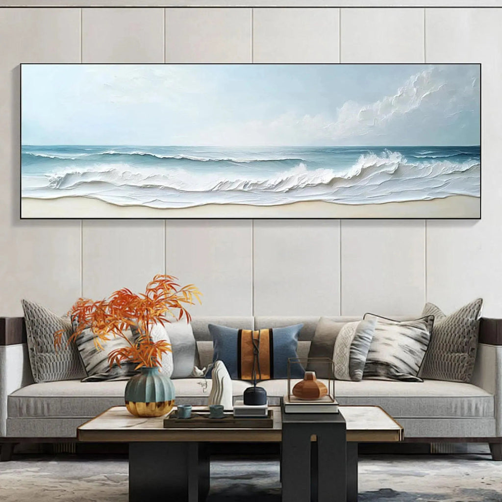 Liam O'Connell "Ocean Waves Panoramic" painting with textured impasto waves, displayed above a sofa in a living room.
