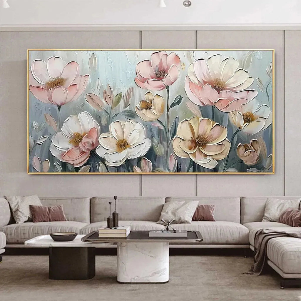 Textured impasto painting of pink and white blossoms displayed in a modern living room above a sectional sofa.