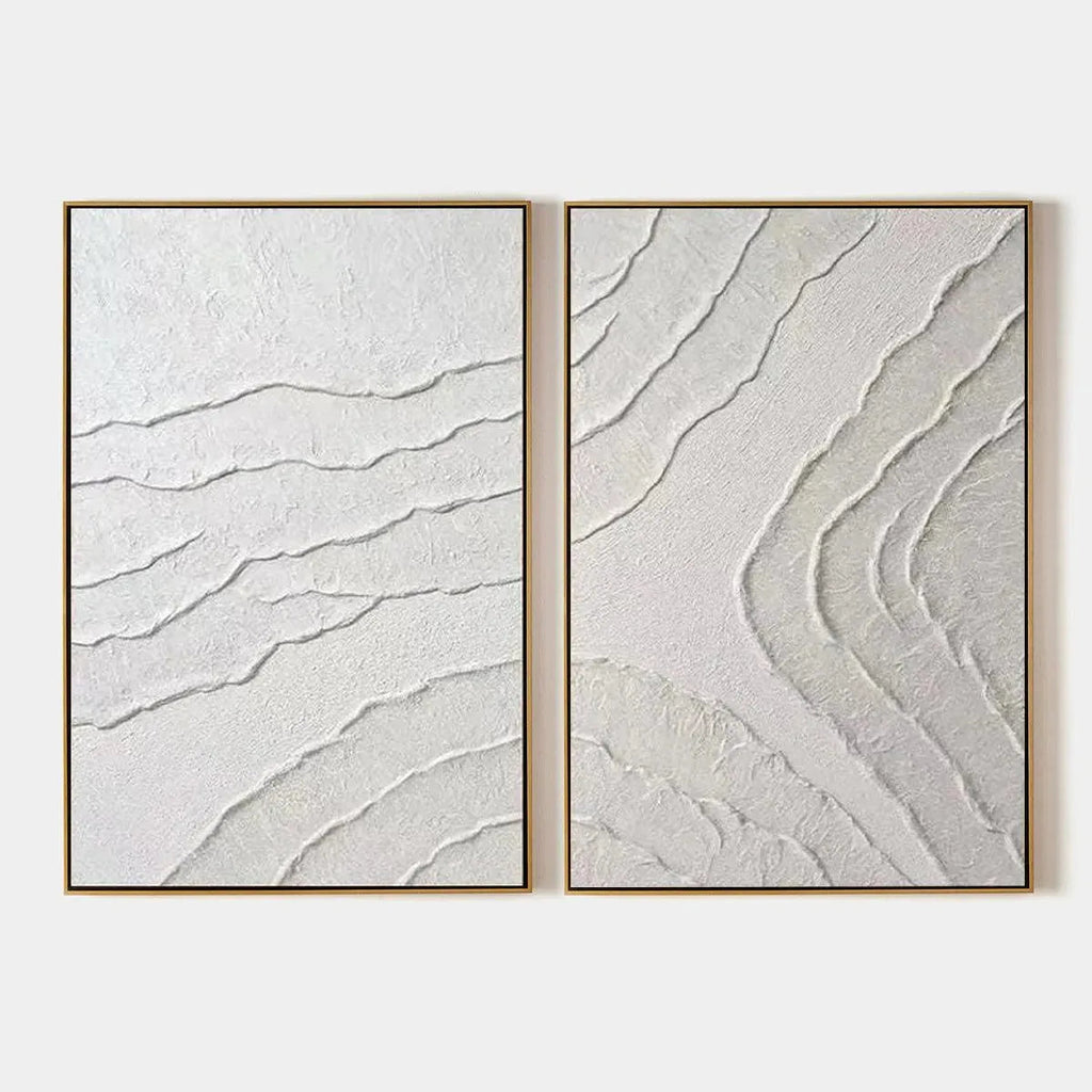 White Textured Lines Diptych by Isabella Rossi, abstract textured white lines on canvas, gold frame. Modern wall art.