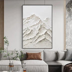 Textured white mountain impasto painting by Liam O'Connell, framed in black, above grey sofa.