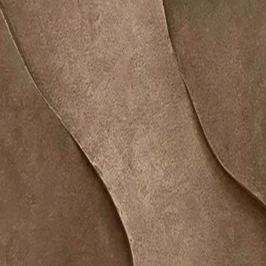 Close-up of brown abstract painting with textured angular curves, showcasing layered depth.