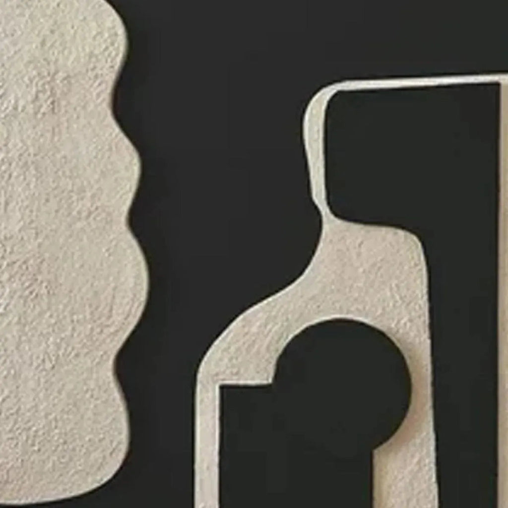 INK BLOT DUO: Close-up texture of abstract art with raised cream organic shapes on black background.