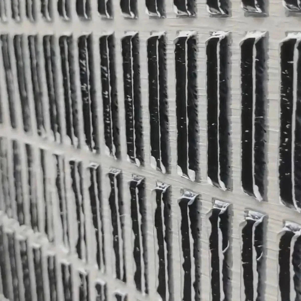 WOVEN TEXTURE painting, close-up of grey and white textured grid pattern by Javier Ramirez, showcasing dimensional detail.